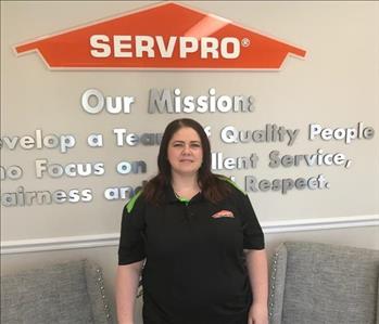 Female employee in front of SERVPRO sign
