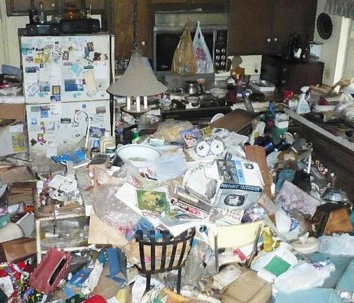 Kitchen with garbage and trash all over floor about knee high