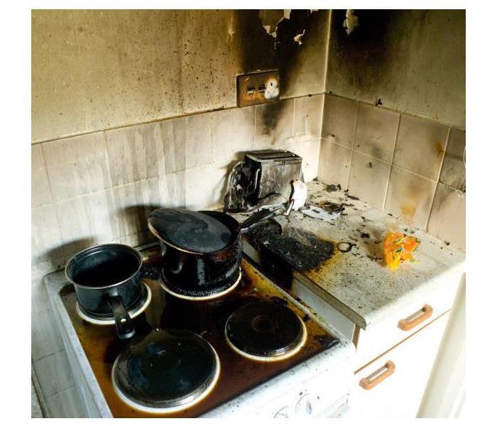 Stove with pot on it and has had a fire so all burned