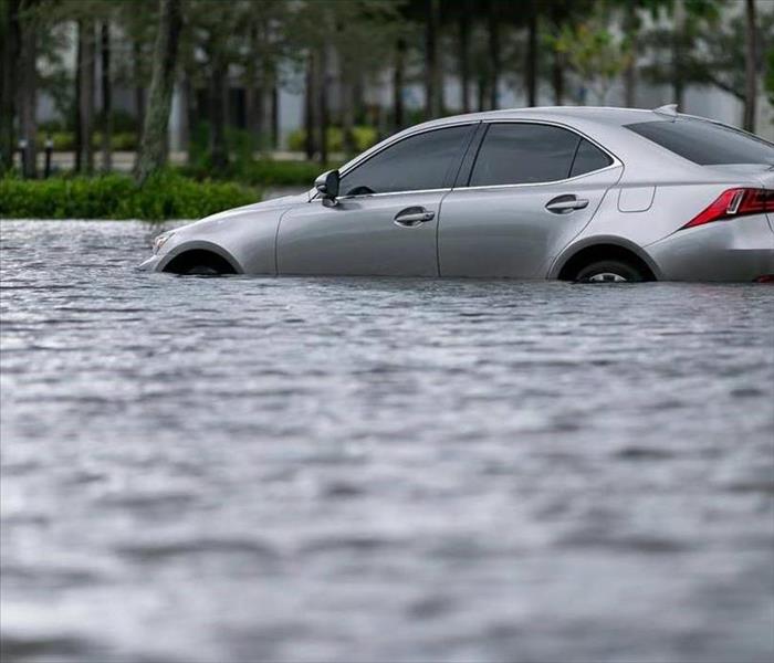 Car with flood water up to the exterior of the doors