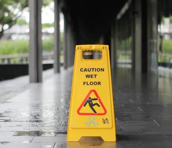 Caution Wet Floor sign yellow in color on a wet floor
